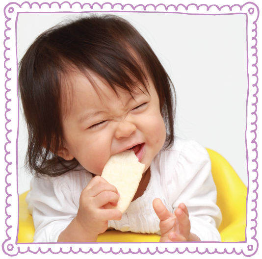 Happy Baby eating Rice Rusk